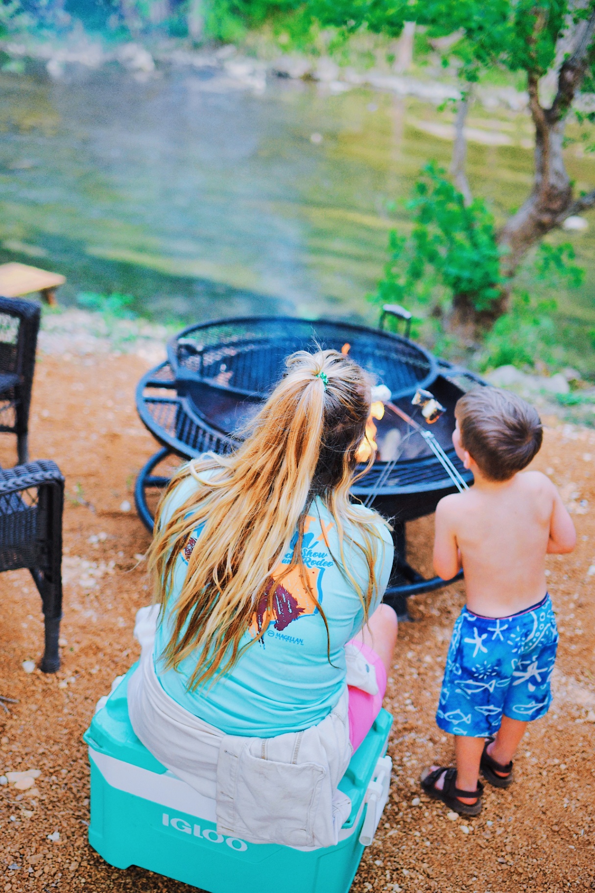 Family grilling by the river