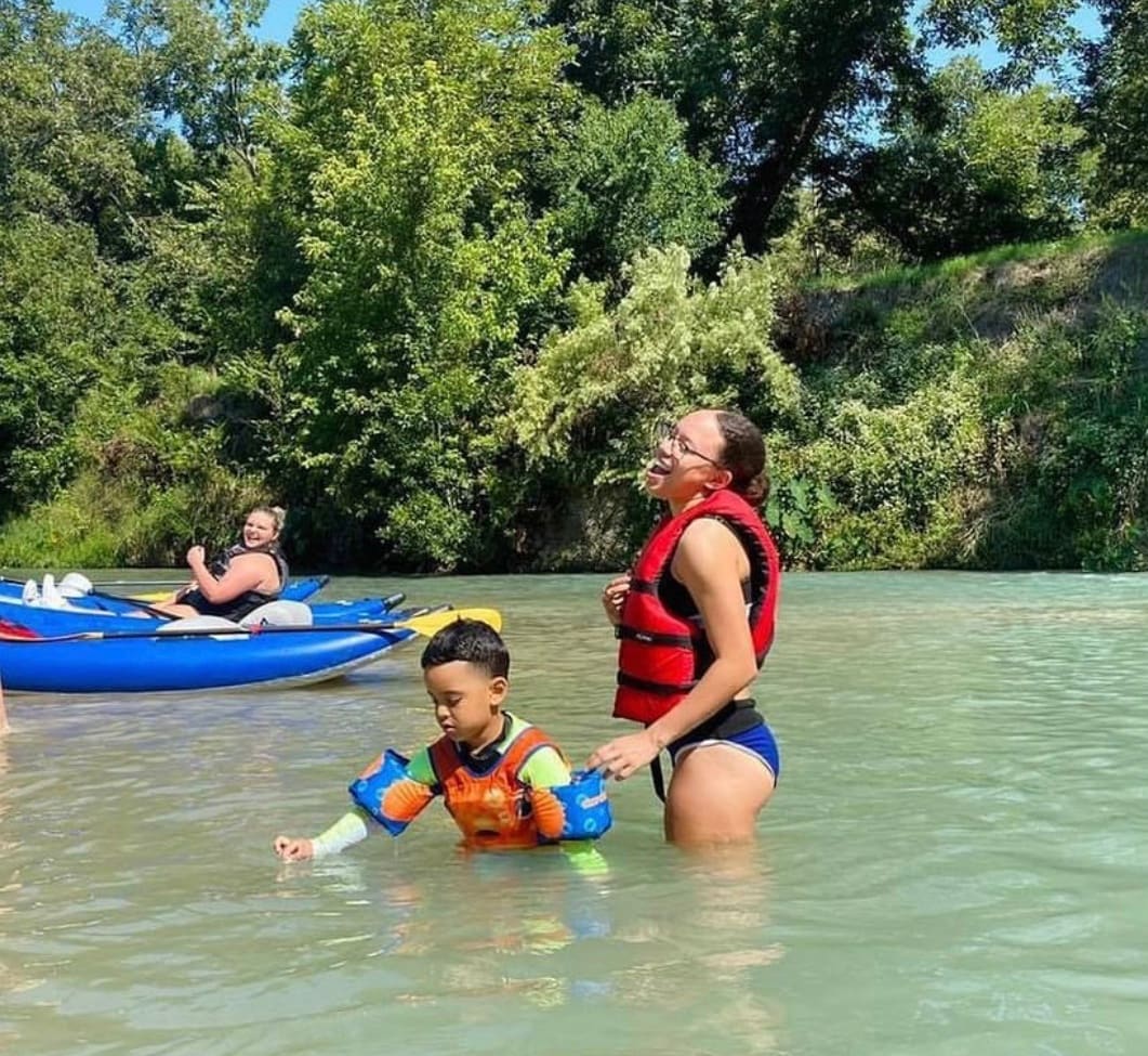 Family swimming at a riverfront vacation rental near San Antonio, TX