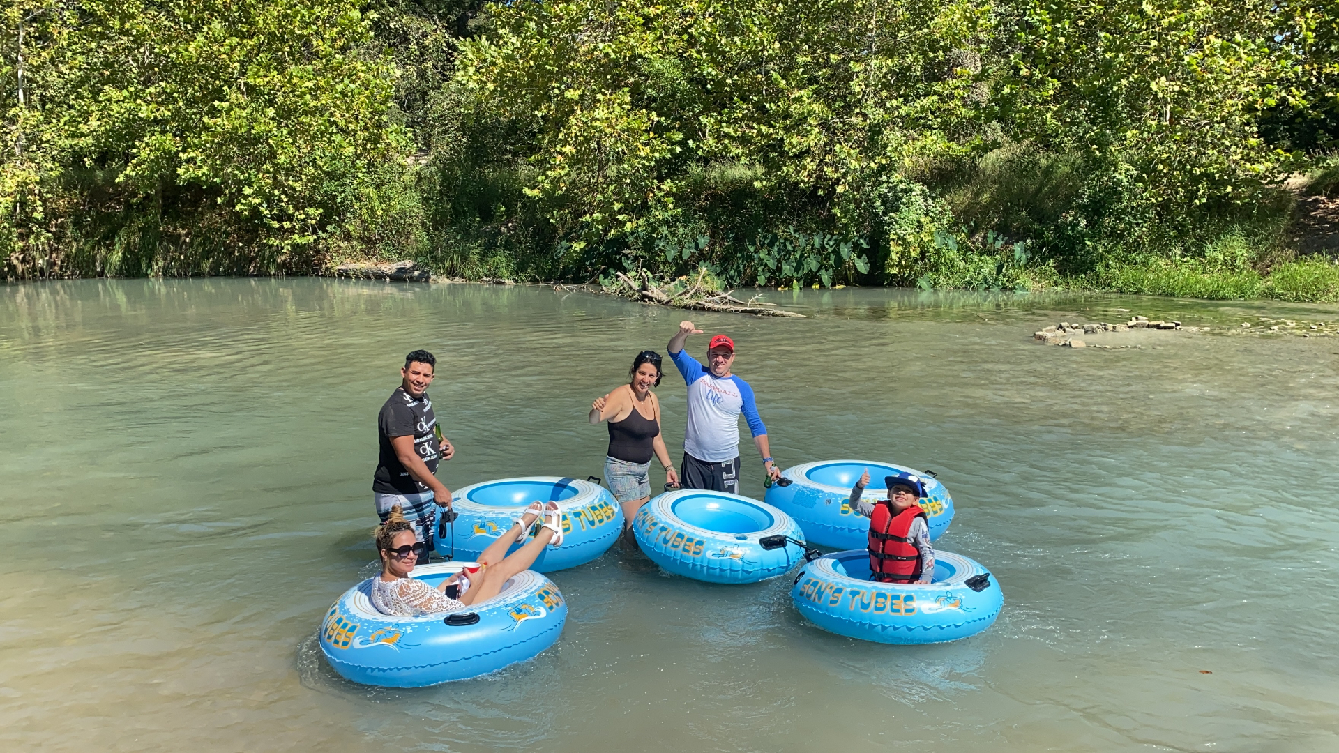 Family enjoying tubes on the river